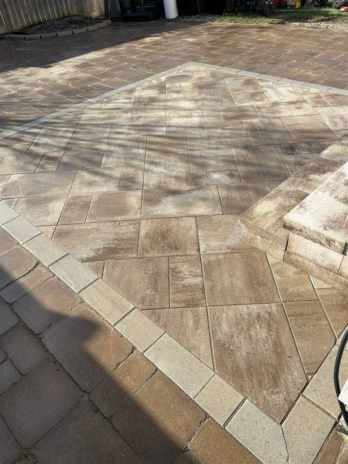Tan interlock patio laid on the diagonal with a light border course in Kingston, Ontario